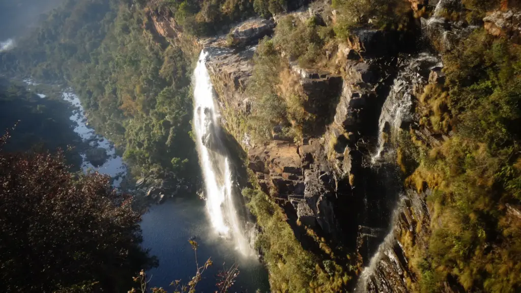 Lisbon Falls on South Africa's Panorama Route, surrounded by mountains and vegetation.